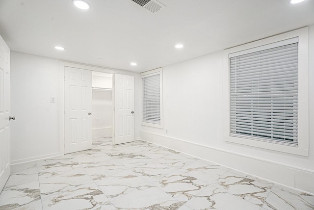 3515 Winnie St, Galveston, TX 77550 - unfurnished bedroom with recessed lighting, light marble finish flooring, and a closet
