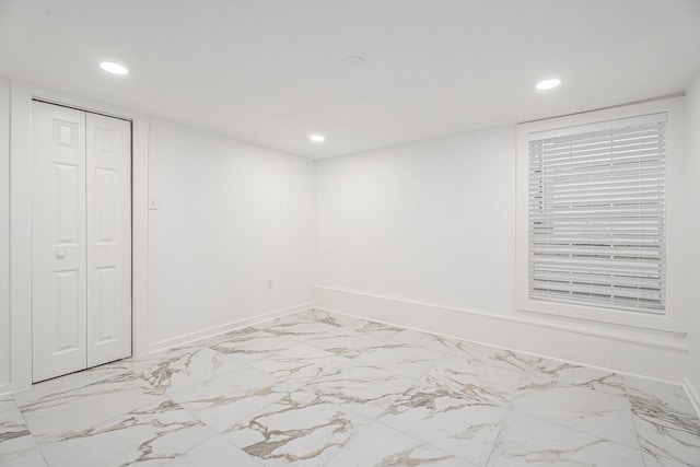 3515 Winnie St, Galveston, TX 77550 - unfurnished bedroom featuring recessed lighting, marble finish flooring, and a closet