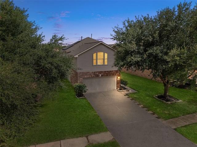 20523 Ranch Mill Ln, Cypress, TX 77433 - view of front of property with an attached garage, a front lawn, roof mounted solar panels, and driveway