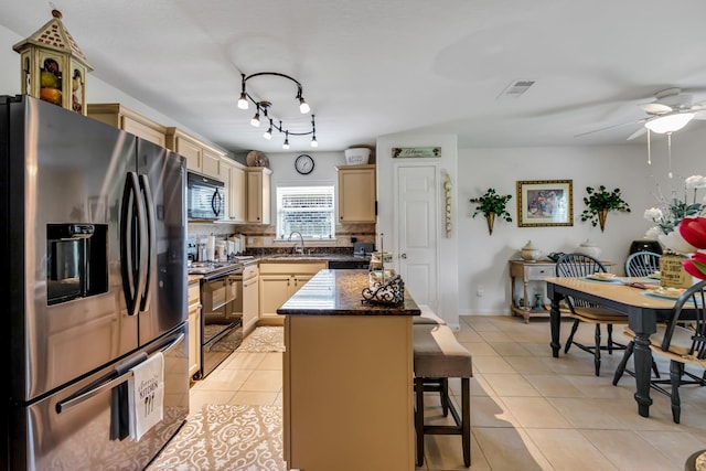 12114 Mabel Ln, Pinehurst, TX 77362 - kitchen with black appliances, light tile patterned floors, a ceiling fan, backsplash, and a kitchen bar