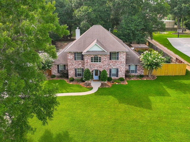 18988 Ocean Mist Ct, Montgomery, TX 77356 - colonial home with a chimney and brick siding