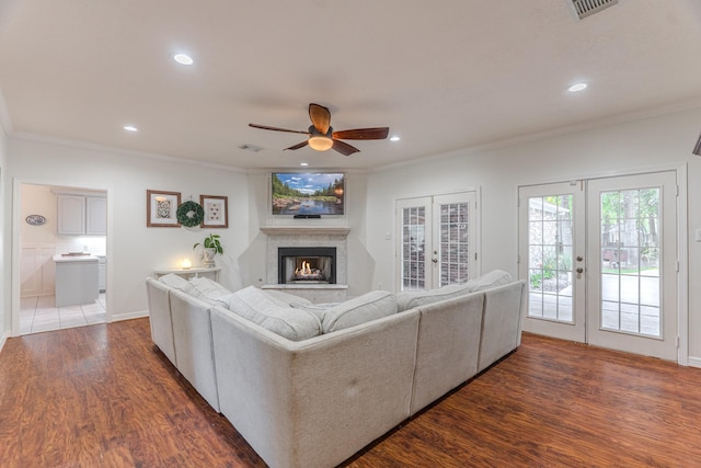 18988 Ocean Mist Ct, Montgomery, TX 77356 - living room with french doors, ceiling fan, crown molding, wood finished floors, and a lit fireplace