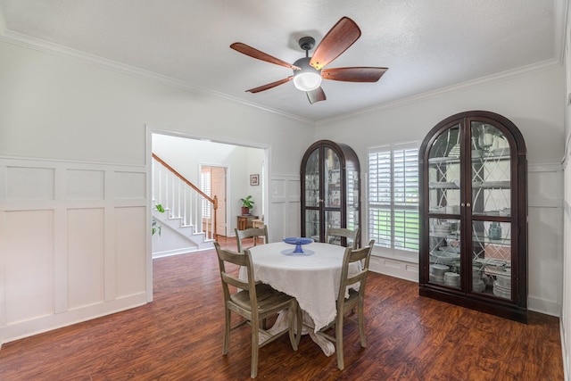 18988 Ocean Mist Ct, Montgomery, TX 77356 - dining area with a decorative wall, dark wood-style floors, stairway, crown molding, and ceiling fan