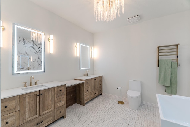 18988 Ocean Mist Ct, Montgomery, TX 77356 - full bathroom with double vanity, a freestanding tub, and a chandelier