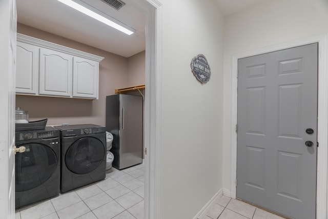 18988 Ocean Mist Ct, Montgomery, TX 77356 - laundry room with washing machine and clothes dryer, light tile patterned floors, and cabinet space