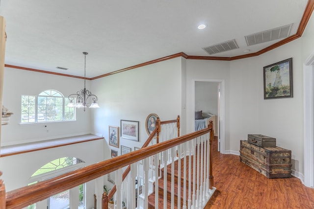18988 Ocean Mist Ct, Montgomery, TX 77356 - hallway with an upstairs landing, wood finished floors, a chandelier, recessed lighting, and crown molding