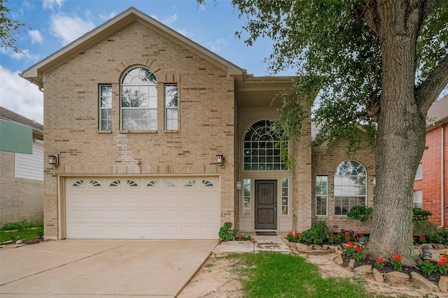 23035 Canal Rd, Richmond, TX 77406 - traditional home with driveway, an attached garage, and brick siding