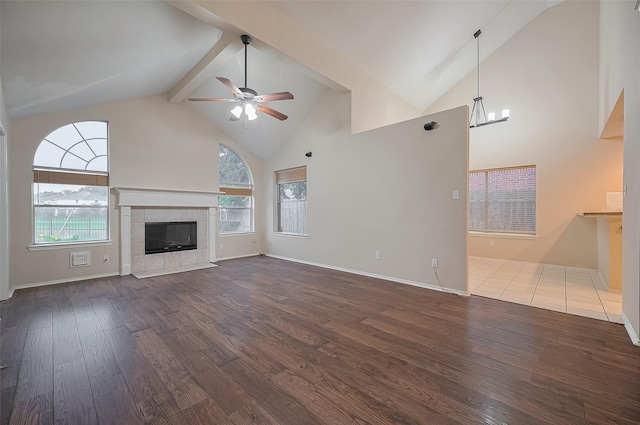 23035 Canal Rd, Richmond, TX 77406 - unfurnished living room featuring dark wood-type flooring, high vaulted ceiling, plenty of natural light, ceiling fan, and beam ceiling