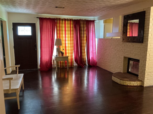 416 Fenn St, Houston, TX 77018 - living area featuring wood finished floors, a fireplace, and a textured ceiling