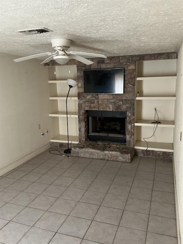 416 Fenn St, Houston, TX 77018 - unfurnished living room featuring a ceiling fan, a stone fireplace, a textured ceiling, and light tile patterned floors