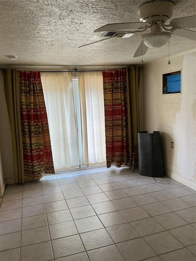 416 Fenn St, Houston, TX 77018 - unfurnished room with a ceiling fan, tile patterned floors, and a textured ceiling