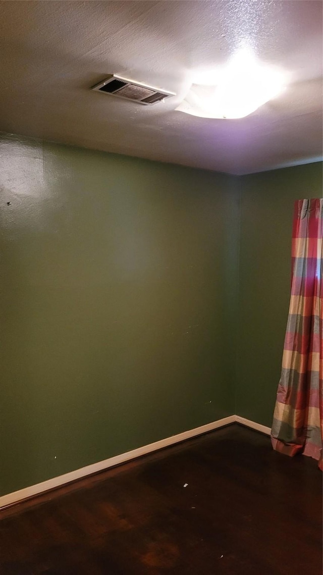 416 Fenn St, Houston, TX 77018 - unfurnished room with baseboards and dark wood-type flooring