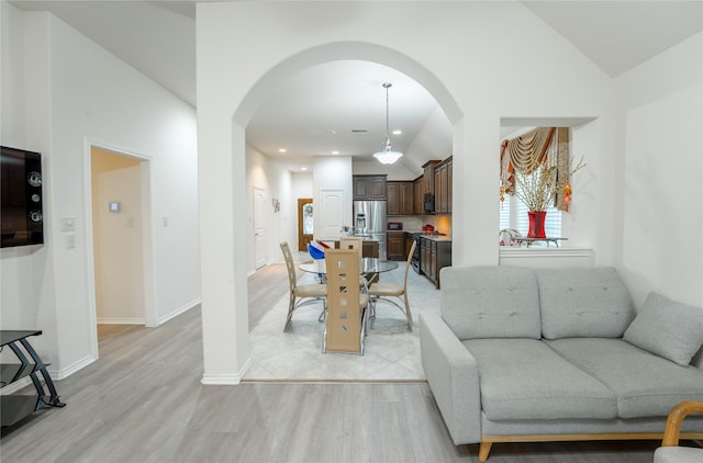 2627 Rosepoint Ct, Fresno, TX 77545 - living area with light wood-style flooring, arched walkways, and lofted ceiling