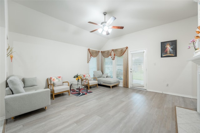 2627 Rosepoint Ct, Fresno, TX 77545 - sitting room featuring ceiling fan, light wood-style floors, lofted ceiling, and a fireplace with flush hearth