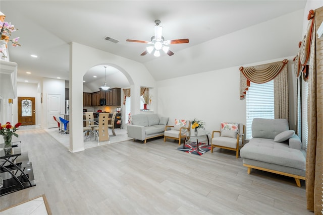 2627 Rosepoint Ct, Fresno, TX 77545 - living area featuring arched walkways, plenty of natural light, a ceiling fan, lofted ceiling, and light wood-style floors