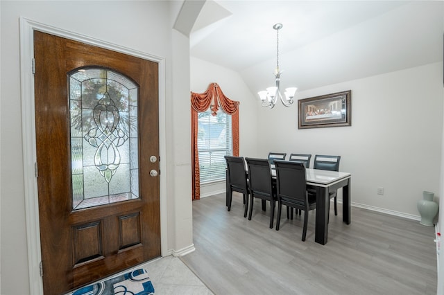 2627 Rosepoint Ct, Fresno, TX 77545 - entryway with a chandelier, lofted ceiling, light wood-style floors, and arched walkways