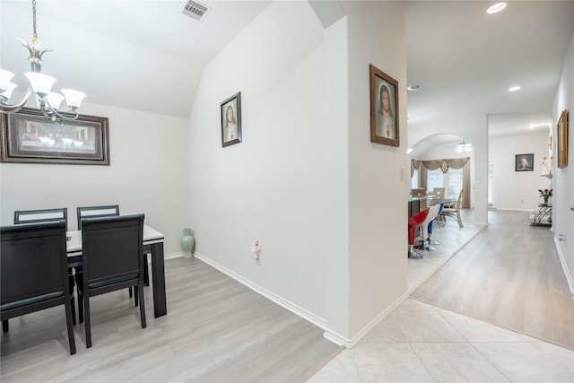 2627 Rosepoint Ct, Fresno, TX 77545 - dining area featuring arched walkways, a chandelier, light wood-style floors, recessed lighting, and lofted ceiling