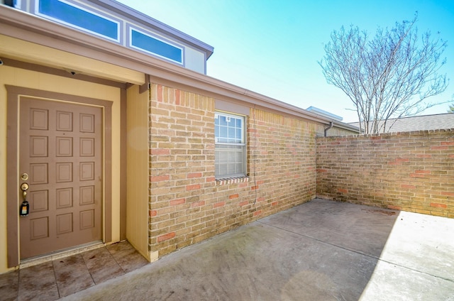 10723 Bexley Dr, Houston, TX 77099 - doorway to property with brick siding and a patio