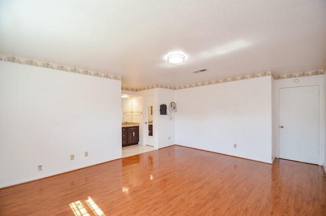 10723 Bexley Dr, Houston, TX 77099 - spare room featuring light wood-style floors and baseboards
