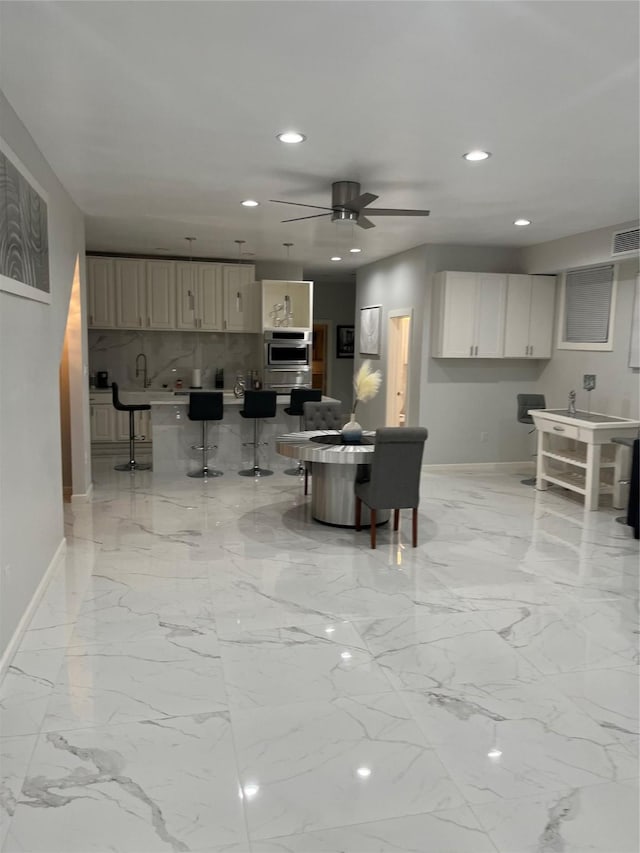 3140 Webster St, Houston, TX 77004 - living room with recessed lighting, a ceiling fan, and light marble finish flooring