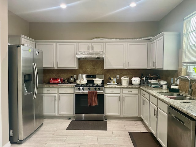 8118 Barnes Ridge Ln, Houston, TX 77072 - kitchen with appliances with stainless steel finishes, extractor fan, decorative backsplash, white cabinets, and recessed lighting