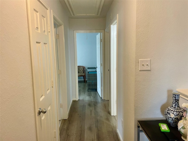 8118 Barnes Ridge Ln, Houston, TX 77072 - corridor featuring attic access, dark wood-style floors, and a textured wall