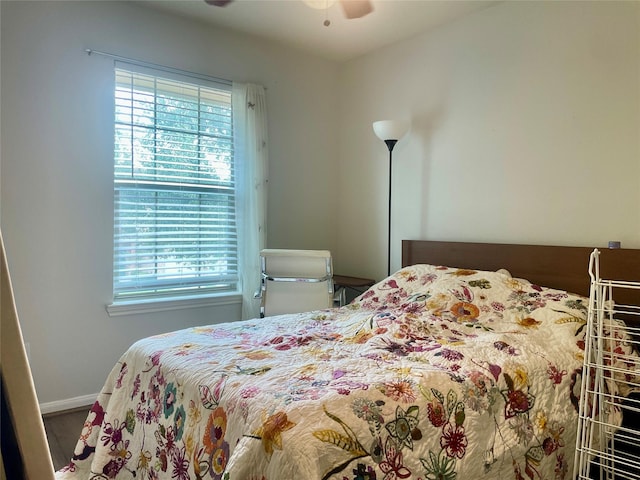 8118 Barnes Ridge Ln, Houston, TX 77072 - bedroom featuring multiple windows, wood finished floors, and a ceiling fan
