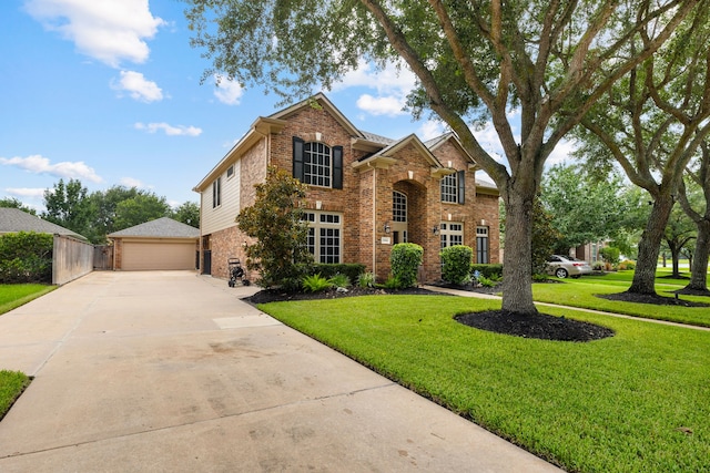 2006 Scarlet Trail Ct, Katy, TX 77494 - traditional-style house featuring brick siding, a front yard, a garage, and concrete driveway