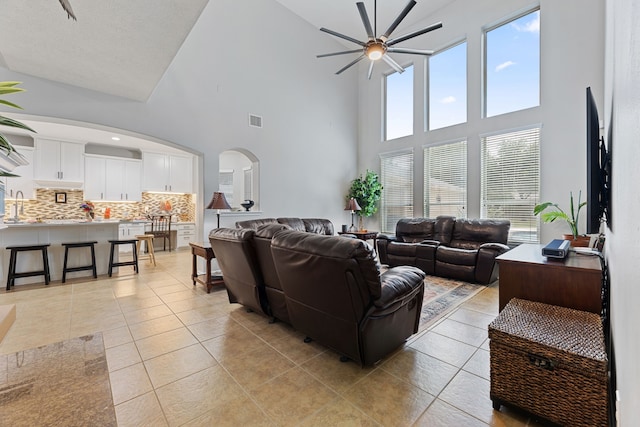 2006 Scarlet Trail Ct, Katy, TX 77494 - living room with ceiling fan, arched walkways, high vaulted ceiling, and light tile patterned flooring