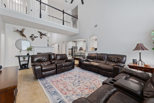 2006 Scarlet Trail Ct, Katy, TX 77494 - living area with arched walkways, a high ceiling, and light tile patterned flooring
