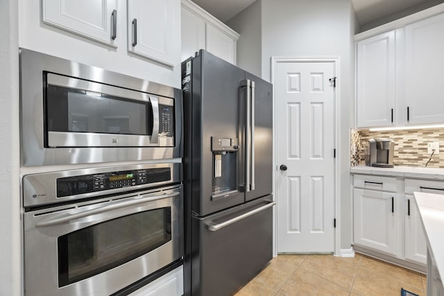2006 Scarlet Trail Ct, Katy, TX 77494 - kitchen featuring stainless steel appliances, white cabinets, decorative backsplash, and light tile patterned flooring