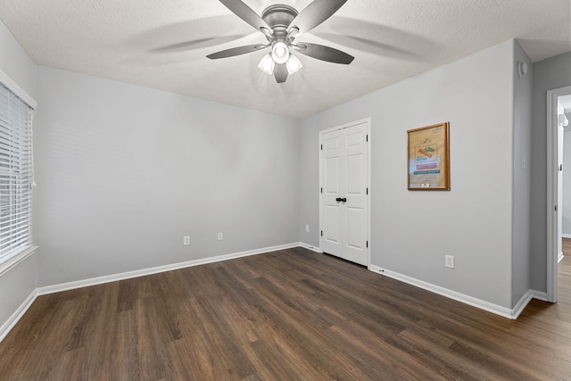2006 Scarlet Trail Ct, Katy, TX 77494 - unfurnished bedroom featuring dark wood finished floors, a textured ceiling, and ceiling fan
