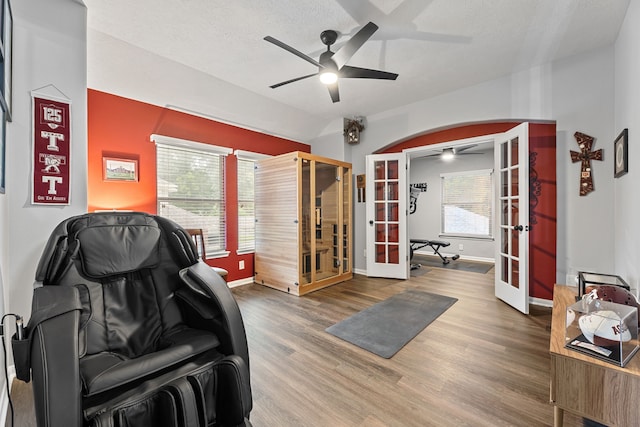 2006 Scarlet Trail Ct, Katy, TX 77494 - living area featuring french doors, ceiling fan, wood finished floors, vaulted ceiling, and a textured ceiling