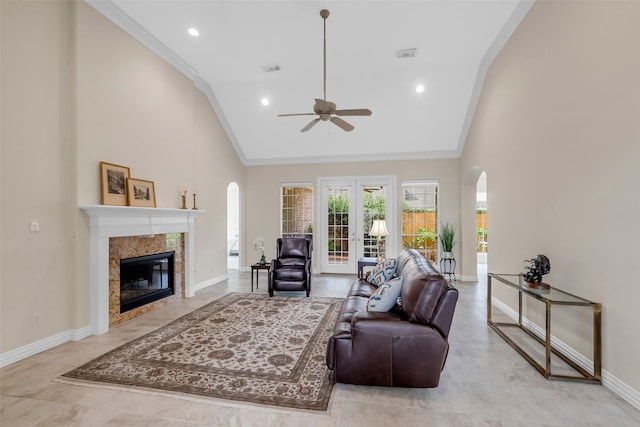 12715 Havant Cir, Houston, TX 77077 - living room featuring arched walkways, ceiling fan, high vaulted ceiling, a high end fireplace, and crown molding