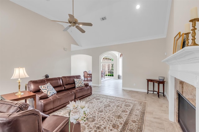 12715 Havant Cir, Houston, TX 77077 - living area with arched walkways, ceiling fan, high vaulted ceiling, a tiled fireplace, and ornamental molding