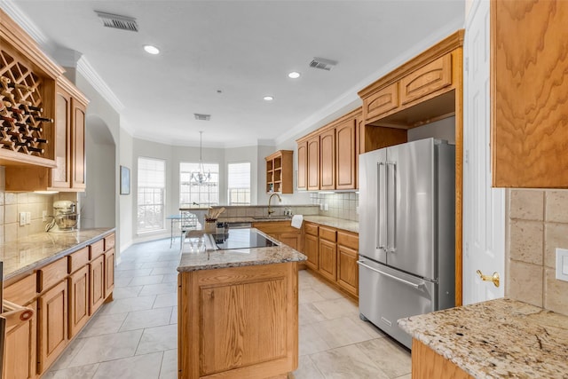 12715 Havant Cir, Houston, TX 77077 - kitchen featuring high end refrigerator, a center island, ornamental molding, light stone counters, and recessed lighting