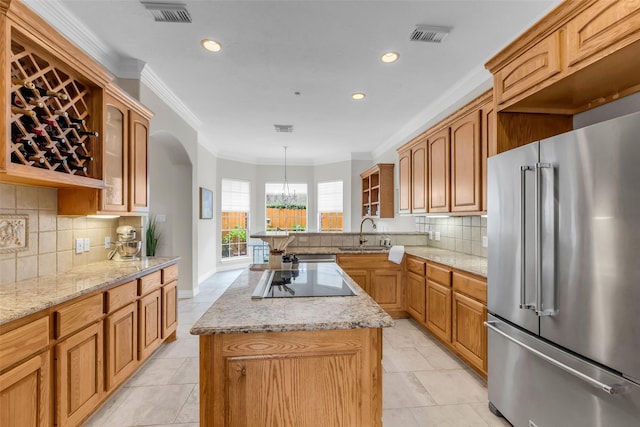 12715 Havant Cir, Houston, TX 77077 - kitchen with high end refrigerator, crown molding, glass insert cabinets, a center island, and black electric stovetop