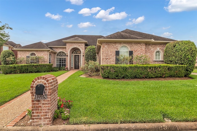 12715 Havant Cir, Houston, TX 77077 - view of front of house featuring a front lawn, brick siding, and roof with shingles