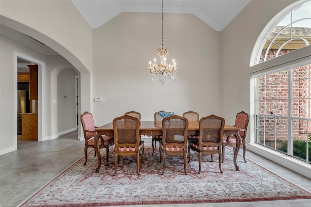 12715 Havant Cir, Houston, TX 77077 - dining space featuring a chandelier, plenty of natural light, arched walkways, and high vaulted ceiling