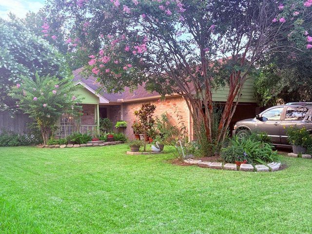 12943 Bamboo Forest Trl, Houston, TX 77044 - view of front of home with a front lawn, brick siding, and covered porch