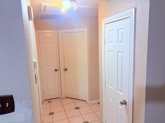 12943 Bamboo Forest Trl, Houston, TX 77044 - hall with light tile patterned flooring and a textured wall