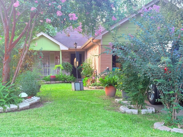 12943 Bamboo Forest Trl, Houston, TX 77044 - view of front of home with a front yard, covered porch, and brick siding