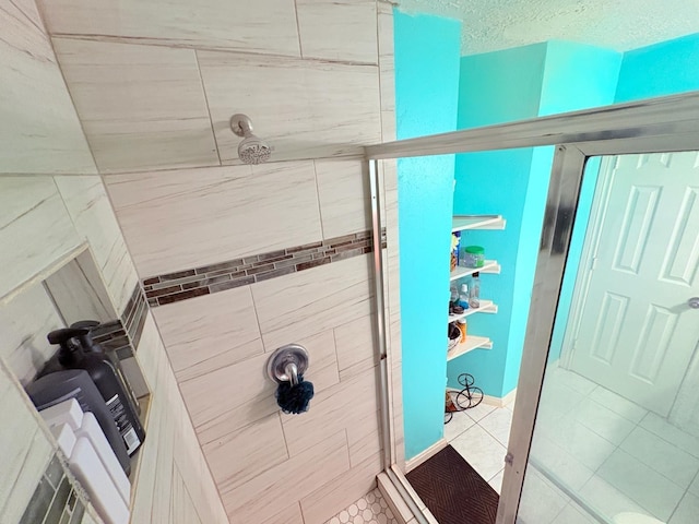 12943 Bamboo Forest Trl, Houston, TX 77044 - bathroom with a tile shower, tile patterned floors, and a textured ceiling