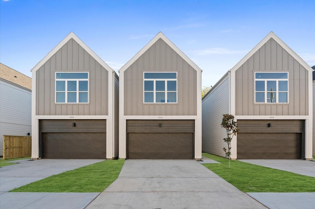 1018 Patton St, Houston, TX 77009 - view of front facade with a garage, concrete driveway, and board and batten siding