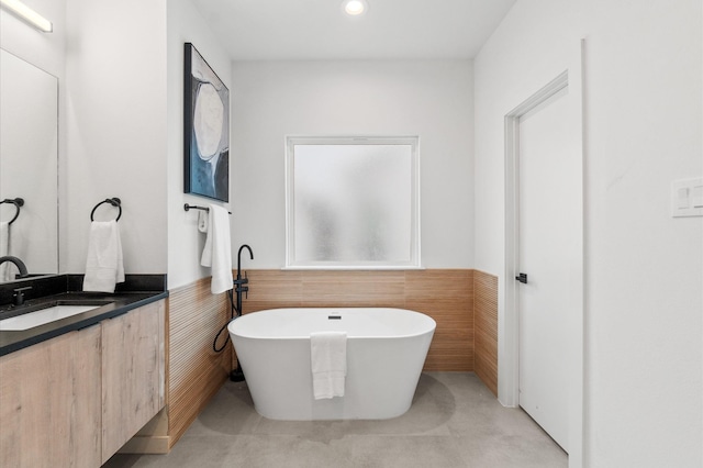 1018 Patton St, Houston, TX 77009 - bathroom with a wainscoted wall, a freestanding bath, vanity, recessed lighting, and tile walls