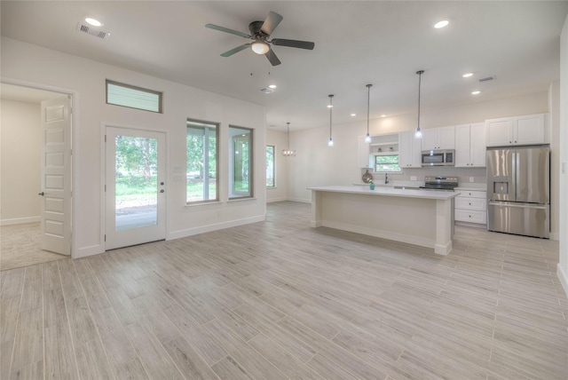 175 Echo Ln, Livingston, TX 77351 - kitchen featuring appliances with stainless steel finishes, white cabinets, a ceiling fan, light countertops, and light wood finished floors