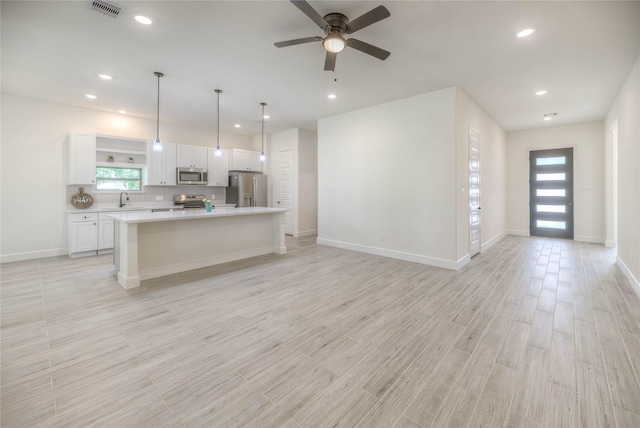 175 Echo Ln, Livingston, TX 77351 - kitchen with appliances with stainless steel finishes, white cabinets, open floor plan, light countertops, and recessed lighting
