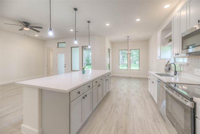 175 Echo Ln, Livingston, TX 77351 - kitchen with appliances with stainless steel finishes, open shelves, light countertops, light wood-style floors, and recessed lighting
