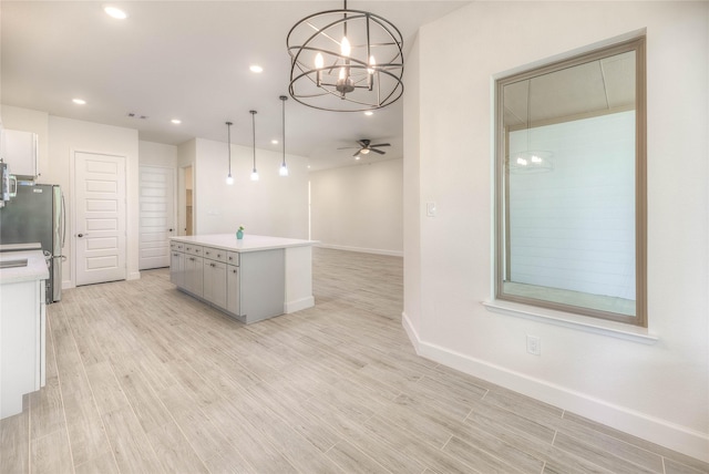 175 Echo Ln, Livingston, TX 77351 - kitchen featuring a chandelier, light countertops, decorative light fixtures, a ceiling fan, and a kitchen island