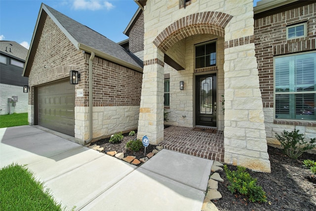 3140 Red Buckeye Ln, Conroe, TX 77301 - entrance to property featuring stone siding, an attached garage, brick siding, concrete driveway, and roof with shingles